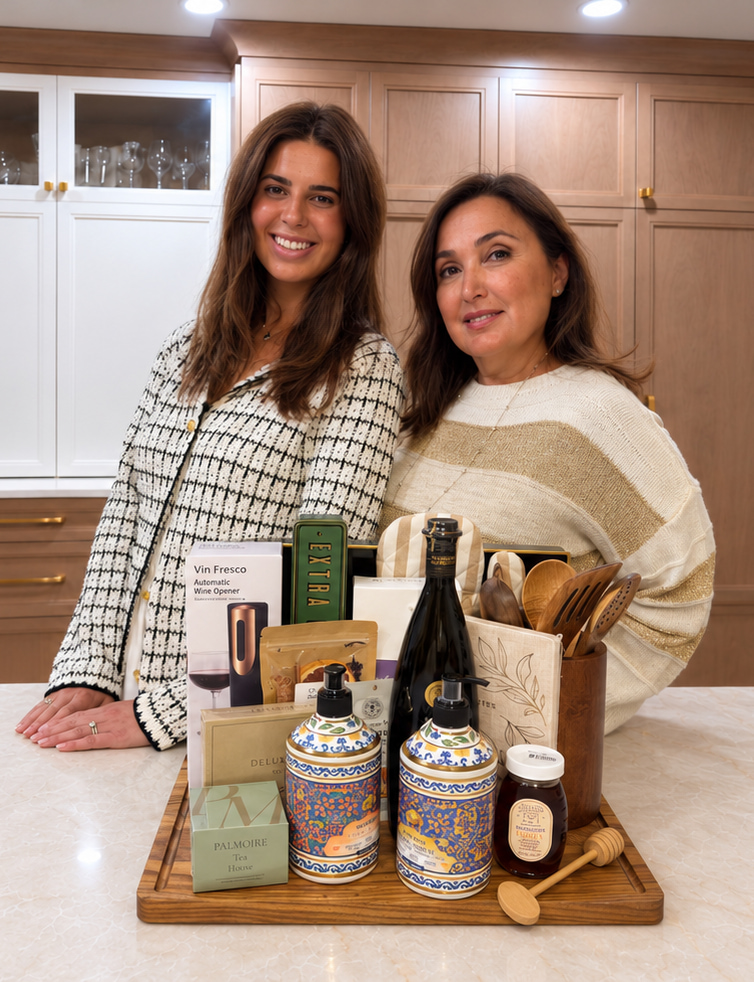 Two women arranging a luxury closing gift on a kitchen island